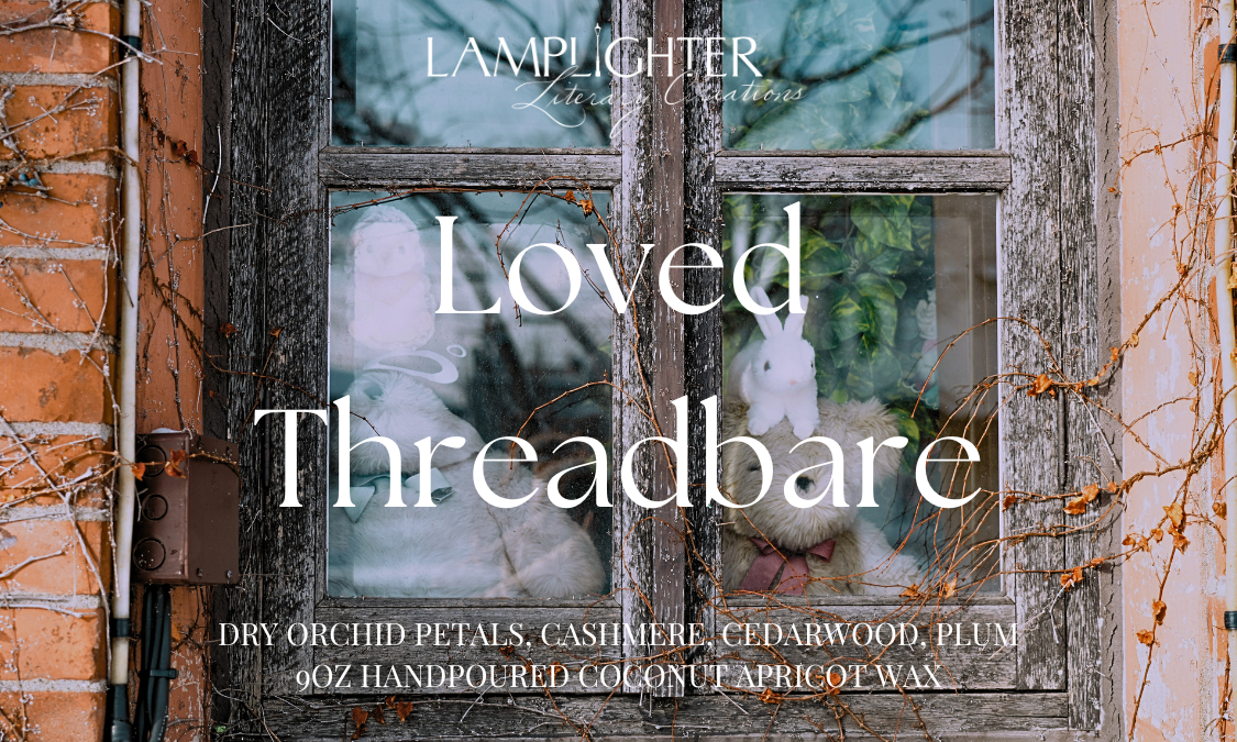 Loved Threadbare candle label with old window setting and featuring the scent notes ‘Dry Orchid Petals,’ ‘Cashmere,’ ‘Cedarwood,' and 'Plum' in decorative serif lettering.